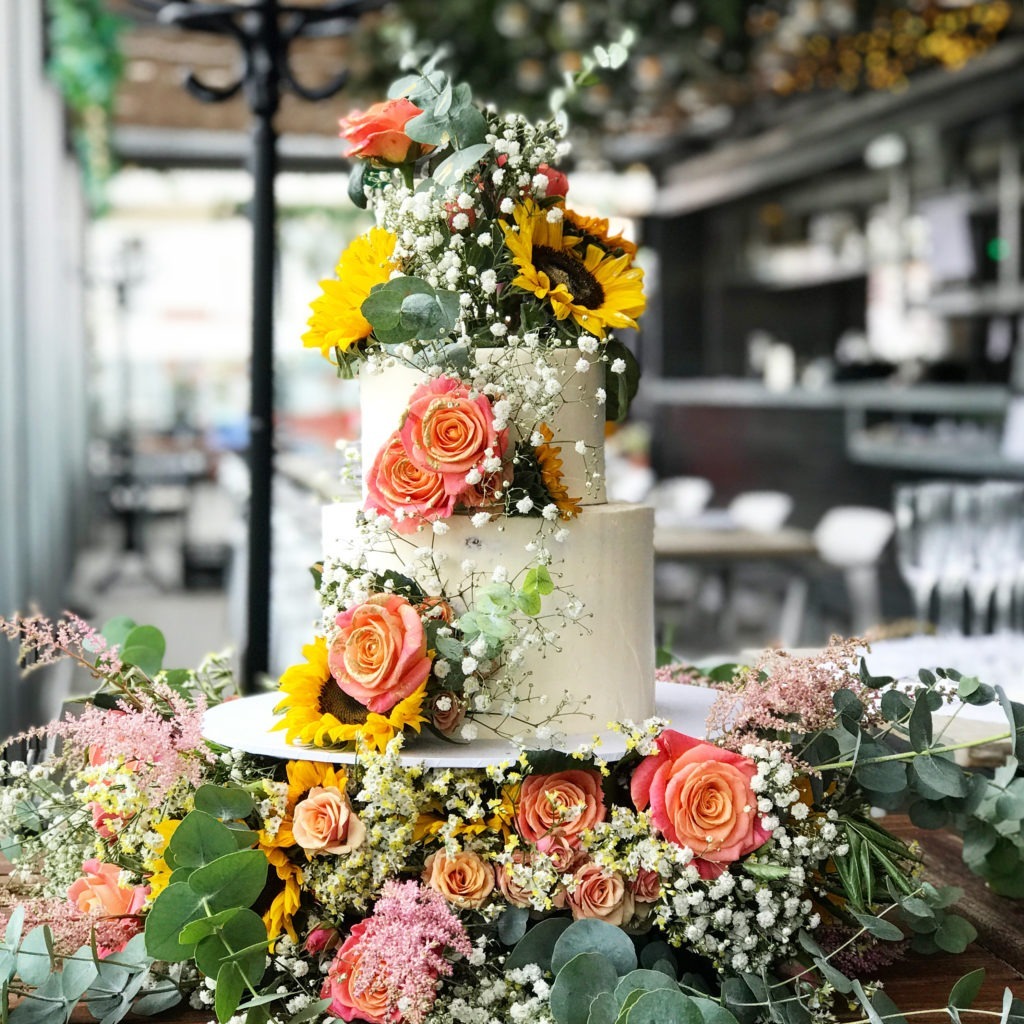 Wire basket cake display with flowers 