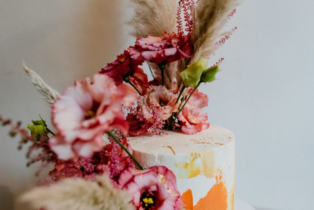 Celebration cake. A Birthday cake with flowers in orange and pink.