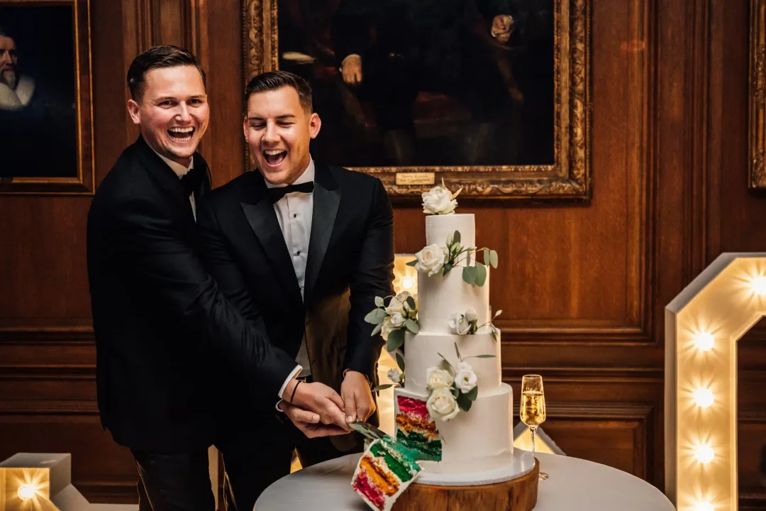 Same sex wedding cake with rainbow inside