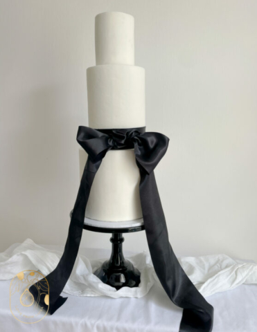 Three tier bow wedding cake