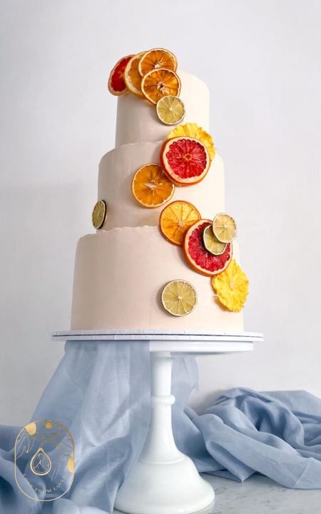 Citrus Slice Wedding Cake. Three tiers with pale pink base. View from below