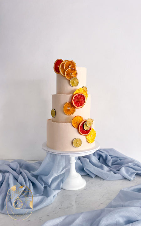 Citrus Slice Wedding Cake. Three tiers with pale pink base.