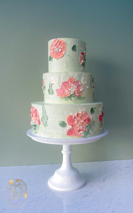 Three tier hand painted buttercream cake in pink and green