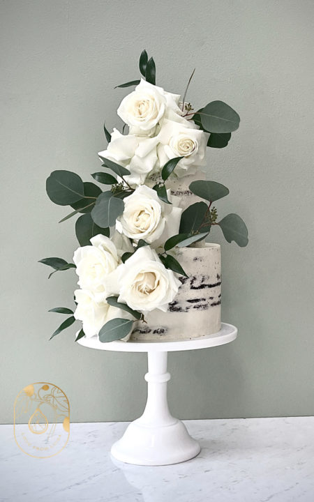 Three Tier Semi Naked Chocolate Wedding Cake with White Roses and Eucalyptus