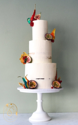 Semi-Naked Wedding Cake. Three tiers with tropical fruit petals.