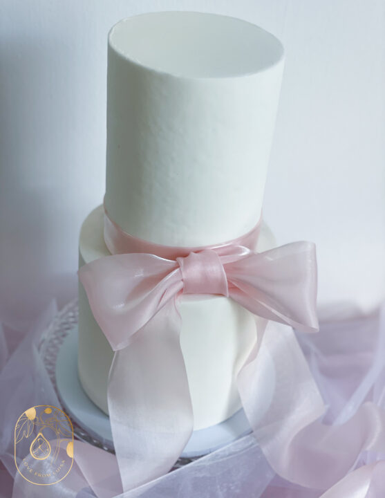 Two tier cake with pink bow design