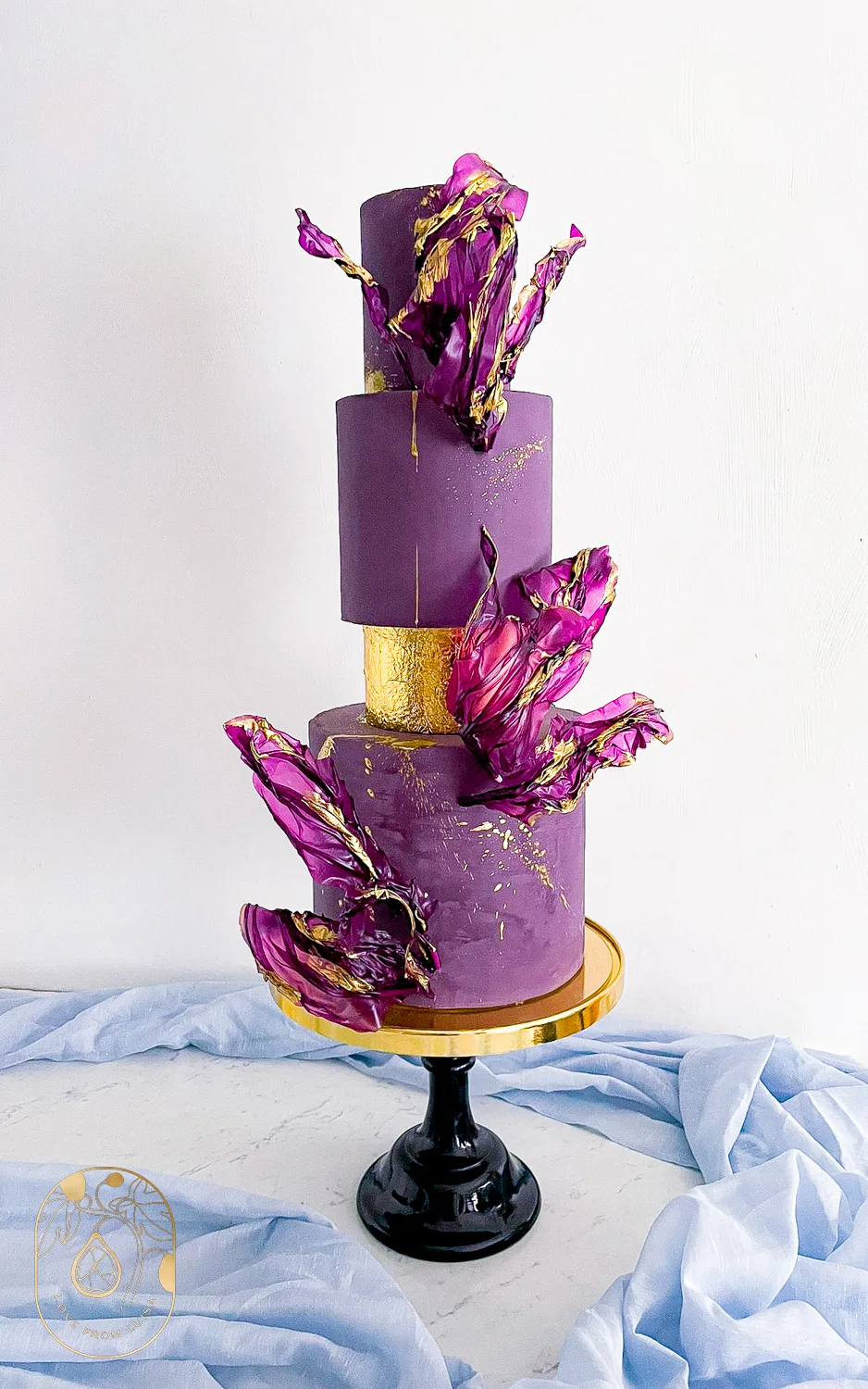 Purple and Gold Wedding Cake Shot from the front with purple details and gold tier