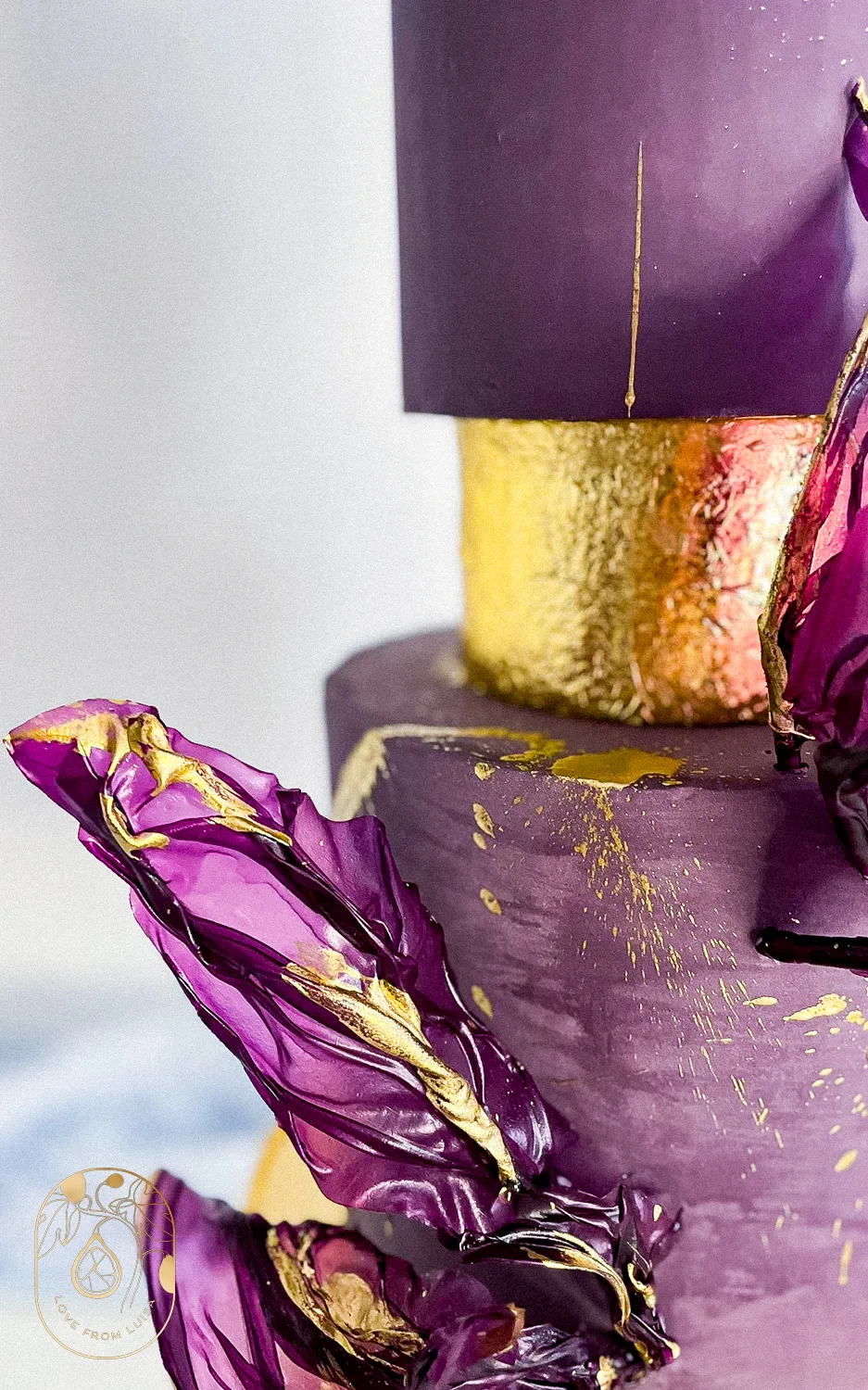 Purple and Gold Wedding Cake Shot from close up with purple details and gold tier