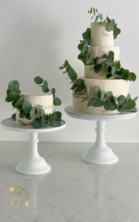 Three tier wedding cake and matching single tier wedding cake with eucalyptus
