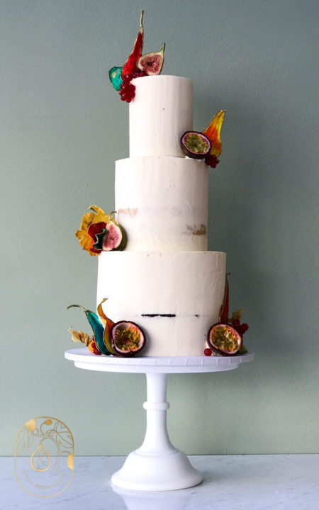 Tree tier wedding cake in semi-naked design with tropical fruits