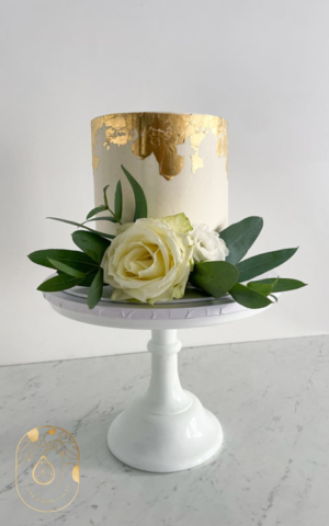 Buttercream Cake with gold leaf halo and white rose and eucalyptus
