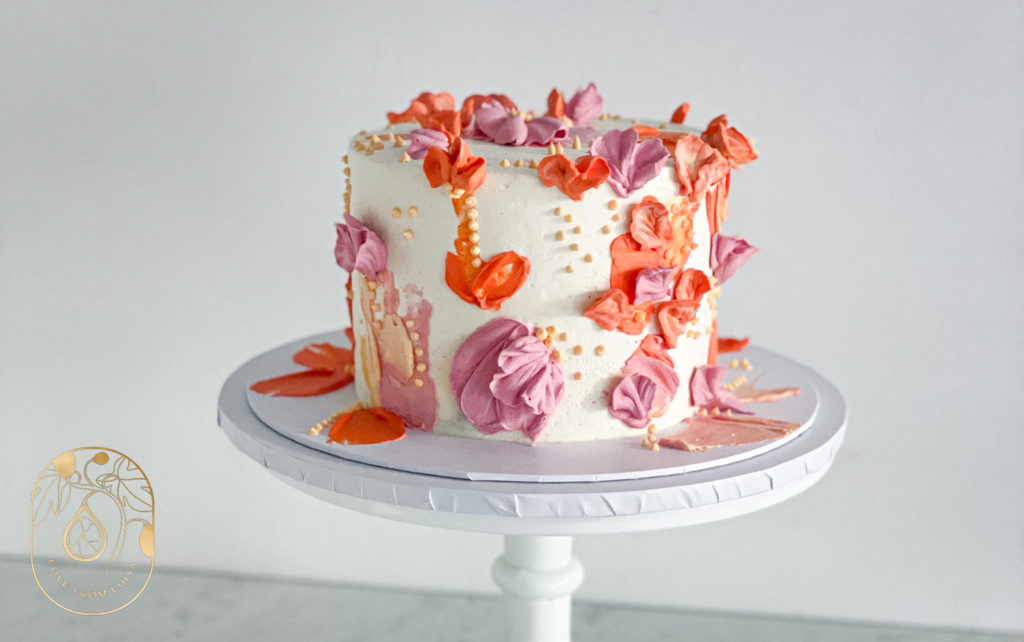 Flower Themed Celebration Cake with Orange and Pink Buttercream Flowers