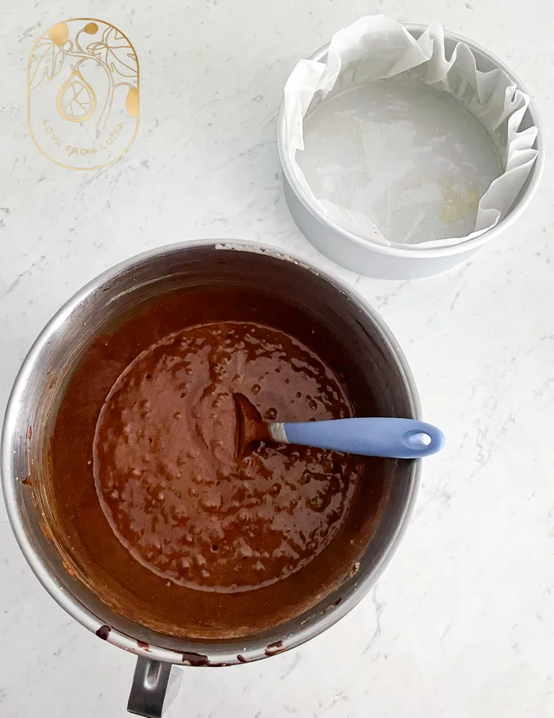 The Real Cost of Custom Cakes: Mixing cake batter for a chocolate torte cake