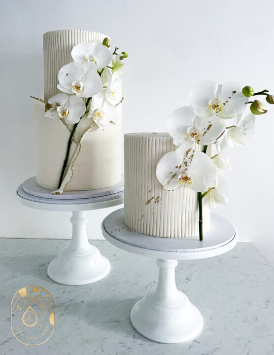 Deconstructed wedding cake display. White wedding cake with orchids