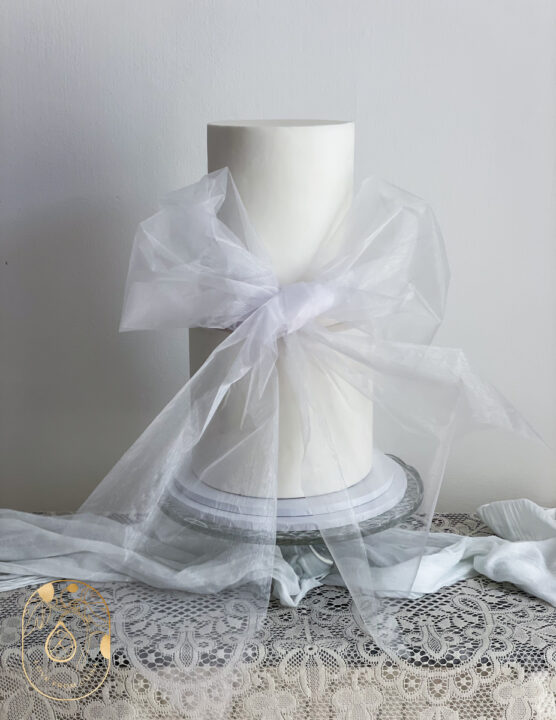 two-tier wedding cake with bow