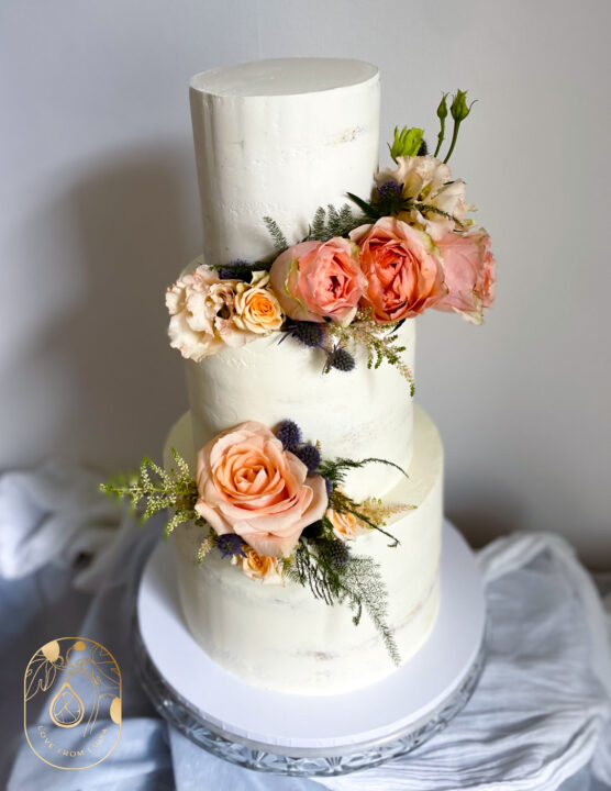 Three tier wedding cake with peach roses