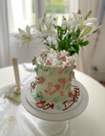 Hand painted celebration cake in pink and green