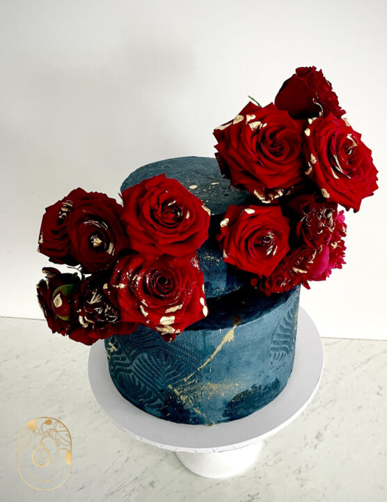 Two tier wedding cake with flowers - deep jewel tones of navy blue and dark red roses