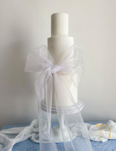 Three tier simple white wedding Cake with Bow