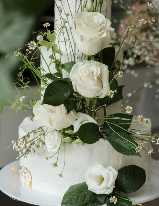Wedding cake with fresh meadow flowers