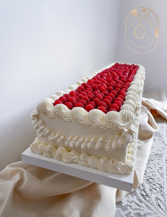 Extra long modern cake - white piped wedding cake with raspberries
