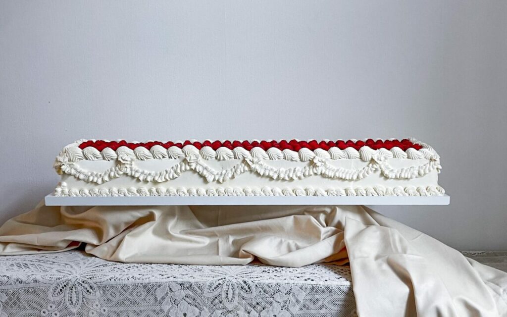 Long vintage style lambeth wedding cake with raspberries