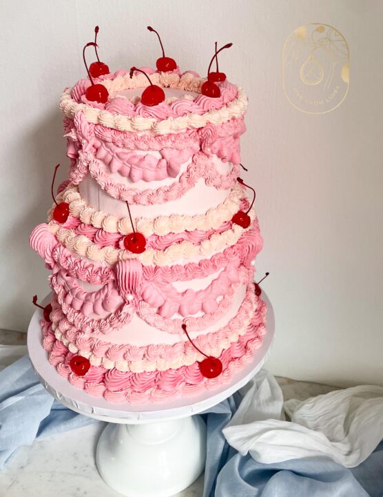 Two tier pink lambeth piped wedding cake with cherries 