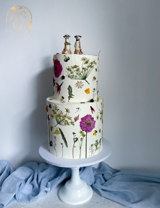 Two tier Pressed Edible Flower Wedding Cake with meerkat cake topper