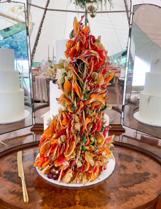 Wedding cake in orange, red and gold fruit petals. My signature wedding cake style. Wedding cake inspiration/gallery 